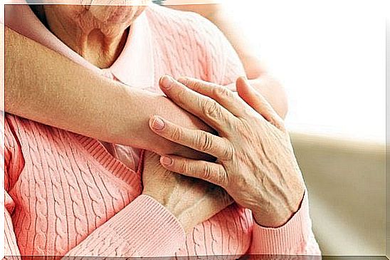 A fold hugging an elderly woman