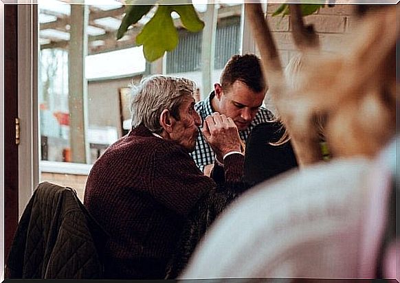 Son and father eating together as an example of informal care