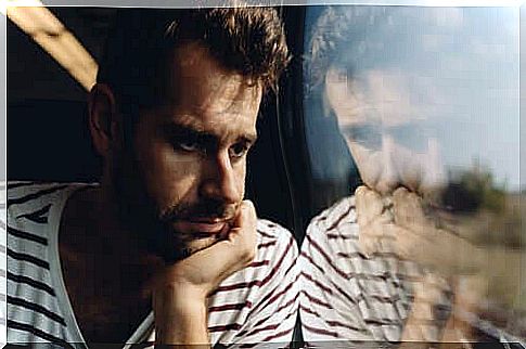 A man stares out the window of a vehicle