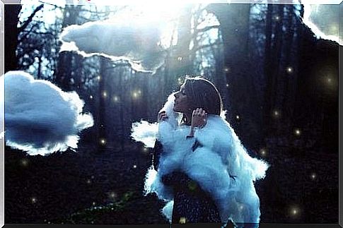 Girl in a forest with clouds around her