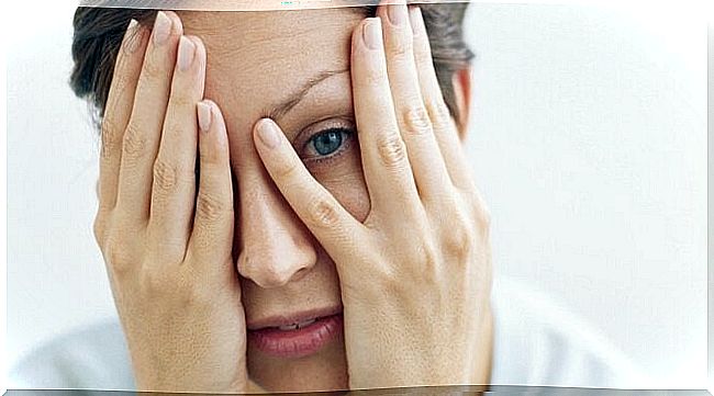 Woman with hands in front of the face