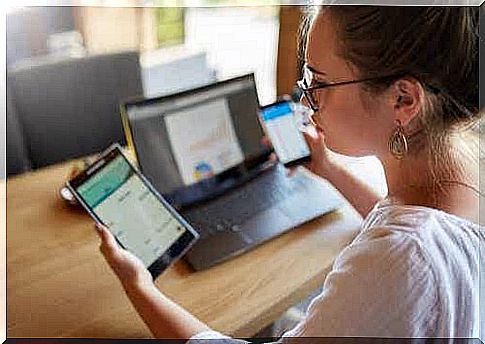 A woman with three electronic devices