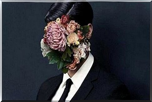 Man with a bunch of flowers in front of his face