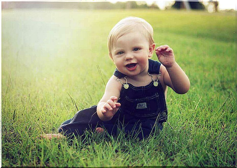 Playing baby in a meadow