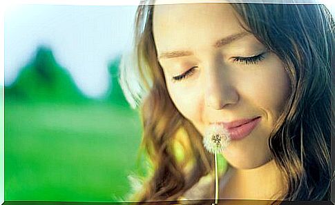 Woman smells flower