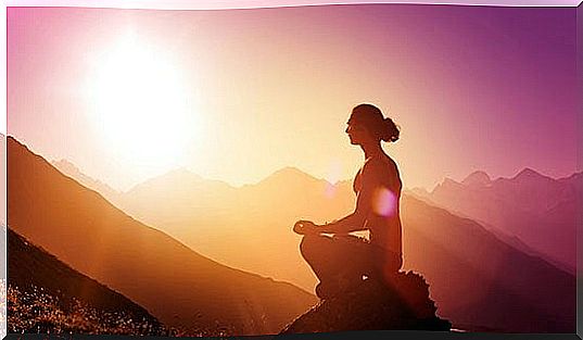 Woman meditating on a mountain